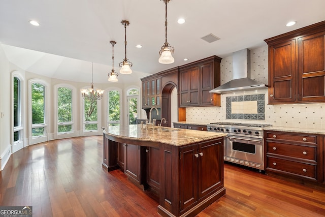 760 River Gate Dr, Atlanta, GA 30350 - kitchen featuring wall chimney exhaust hood, high end range, a chandelier, dark wood finished floors, and decorative backsplash