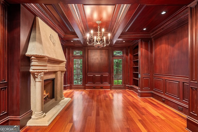 760 River Gate Dr, Atlanta, GA 30350 - unfurnished living room featuring a chandelier, wood finished floors, ornamental molding, wooden ceiling, and a high end fireplace