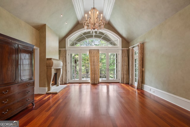 760 River Gate Dr, Atlanta, GA 30350 - entryway with a chandelier, wood finished floors, a glass covered fireplace, and high vaulted ceiling
