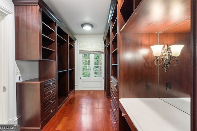 760 River Gate Dr, Atlanta, GA 30350 - walk in closet featuring wood finished floors and a chandelier