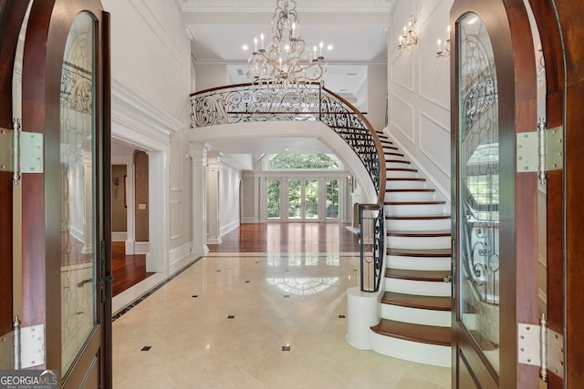 760 River Gate Dr, Atlanta, GA 30350 - entryway with a chandelier, a high ceiling, arched walkways, inlaid floor details, and stairway