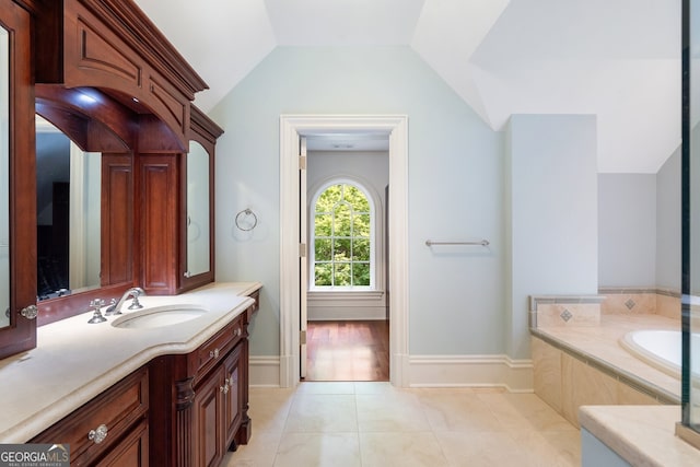 760 River Gate Dr, Atlanta, GA 30350 - bathroom with vanity, a bath, vaulted ceiling, and tile patterned floors