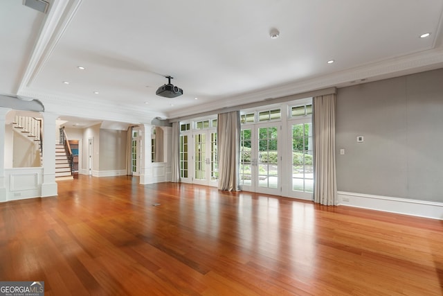 760 River Gate Dr, Atlanta, GA 30350 - unfurnished living room featuring decorative columns, crown molding, wood finished floors, stairway, and recessed lighting