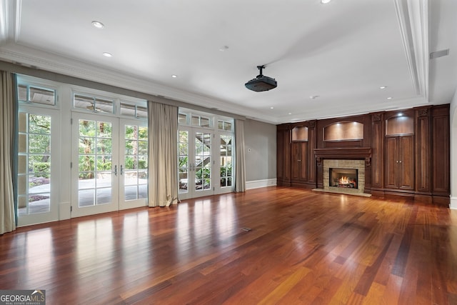 760 River Gate Dr, Atlanta, GA 30350 - unfurnished living room featuring french doors, a warm lit fireplace, ornamental molding, recessed lighting, and wood finished floors