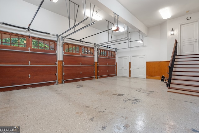 760 River Gate Dr, Atlanta, GA 30350 - garage with a wainscoted wall, a garage door opener, and wooden walls