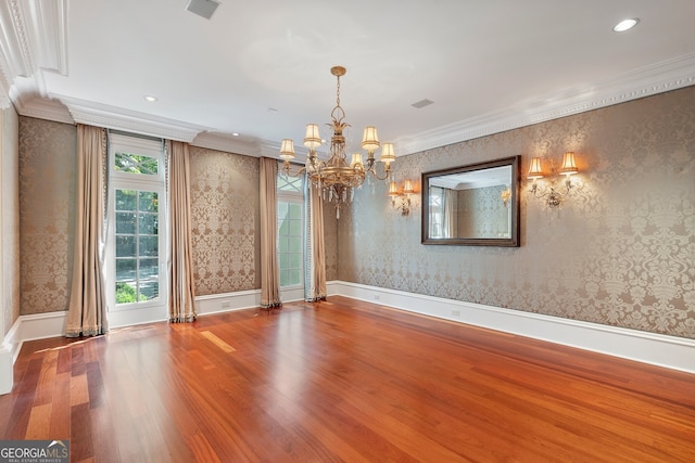 760 River Gate Dr, Atlanta, GA 30350 - spare room with wallpapered walls, a chandelier, wood finished floors, crown molding, and recessed lighting