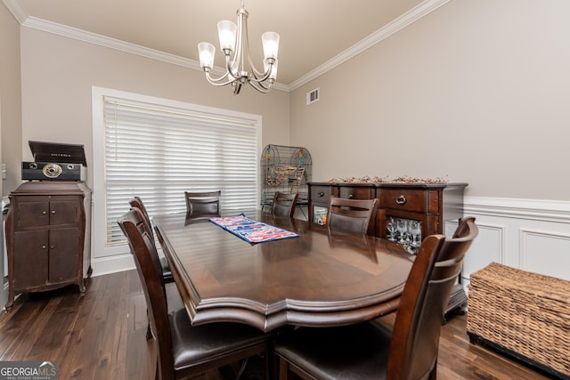 924 Abingdon Cv, Bonaire, GA 31005 - dining area with a chandelier, ornamental molding, dark wood-style floors, and wainscoting