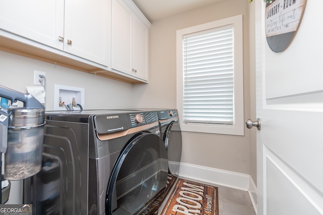 924 Abingdon Cv, Bonaire, GA 31005 - laundry area featuring washing machine and clothes dryer, cabinet space, and baseboards