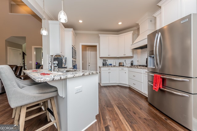 924 Abingdon Cv, Bonaire, GA 31005 - kitchen featuring appliances with stainless steel finishes, a sink, a peninsula, white cabinets, and decorative backsplash