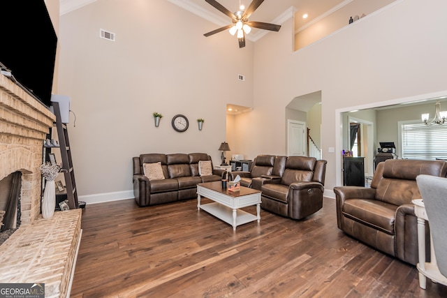 924 Abingdon Cv, Bonaire, GA 31005 - living area featuring a ceiling fan, dark wood-type flooring, ornamental molding, a brick fireplace, and baseboards