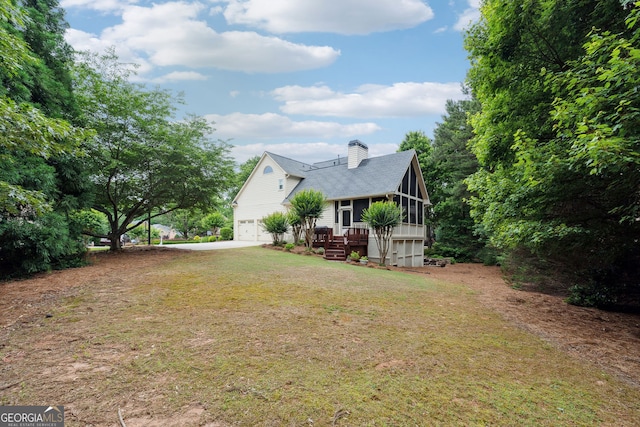 151 Overhill Pt, Alpharetta, GA 30005 - view of grassy yard featuring a sunroom, a garage, and driveway