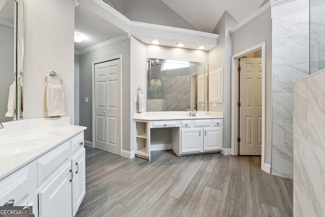 151 Overhill Pt, Alpharetta, GA 30005 - full bathroom with a tile shower, crown molding, two vanities, wood finished floors, and vaulted ceiling