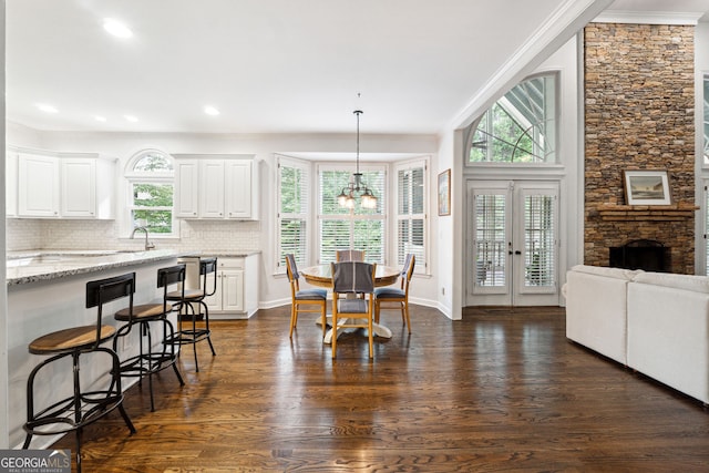 151 Overhill Pt, Alpharetta, GA 30005 - dining room with dark wood finished floors, ornamental molding, a chandelier, recessed lighting, and a fireplace