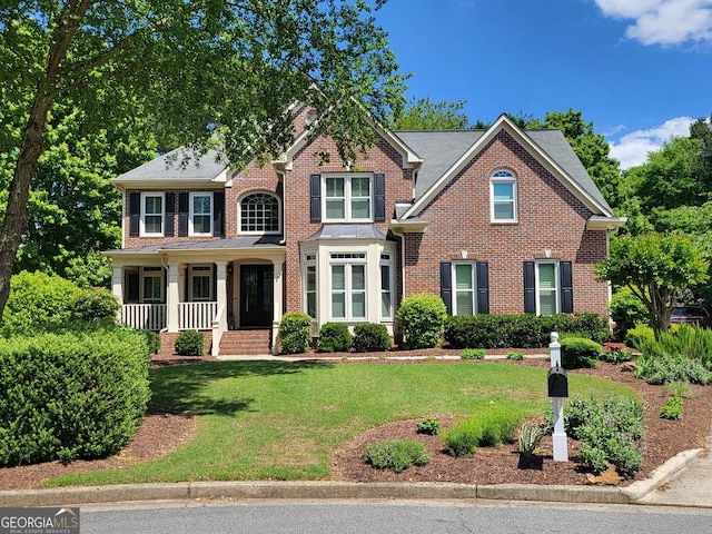 151 Overhill Pt, Alpharetta, GA 30005 - view of front of property with brick siding, a front yard, and a porch