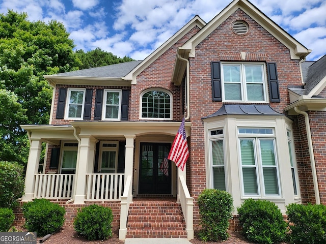 151 Overhill Pt, Alpharetta, GA 30005 - view of front facade with french doors, covered porch, and brick siding