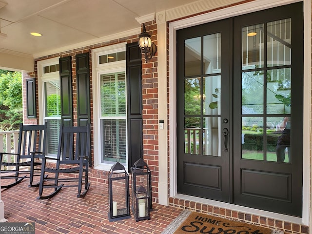 151 Overhill Pt, Alpharetta, GA 30005 - view of exterior entry featuring french doors, a porch, and brick siding