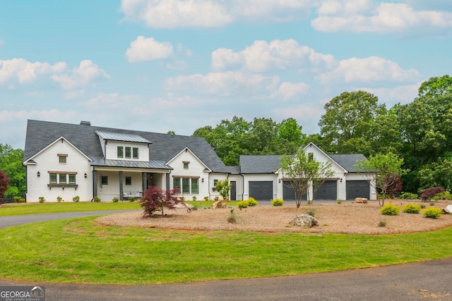 209 Voyles Way, Dawsonville, GA 30534 - modern farmhouse featuring driveway, a standing seam roof, a garage, and a front lawn