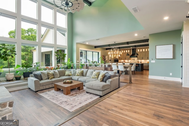209 Voyles Way, Dawsonville, GA 30534 - living area with a chandelier, a high ceiling, wood finished floors, baseboards, and recessed lighting