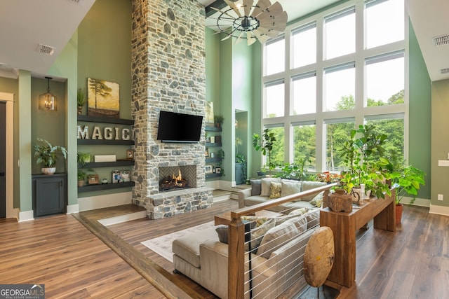 209 Voyles Way, Dawsonville, GA 30534 - living room with a high ceiling, wood finished floors, a fireplace, healthy amount of natural light, and baseboards