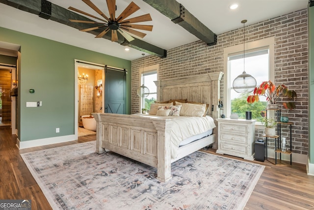 209 Voyles Way, Dawsonville, GA 30534 - bedroom with a barn door, baseboards, beam ceiling, brick wall, and wood finished floors