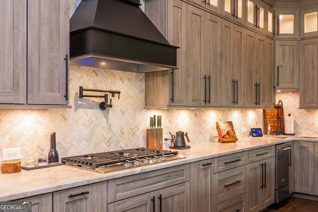 209 Voyles Way, Dawsonville, GA 30534 - kitchen featuring premium range hood, appliances with stainless steel finishes, decorative backsplash, a sink, and glass insert cabinets