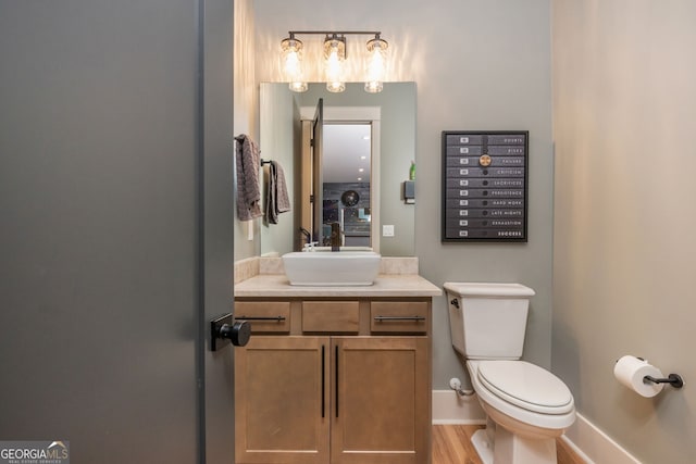 209 Voyles Way, Dawsonville, GA 30534 - bathroom with vanity, toilet, baseboards, and wood finished floors