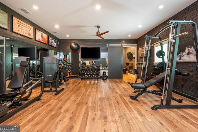 209 Voyles Way, Dawsonville, GA 30534 - workout area featuring a barn door, wood finished floors, brick wall, a ceiling fan, and recessed lighting