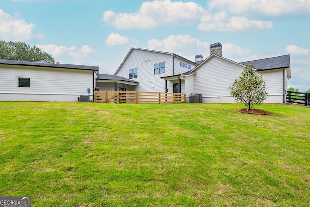 209 Voyles Way, Dawsonville, GA 30534 - back of property featuring cooling unit and a chimney