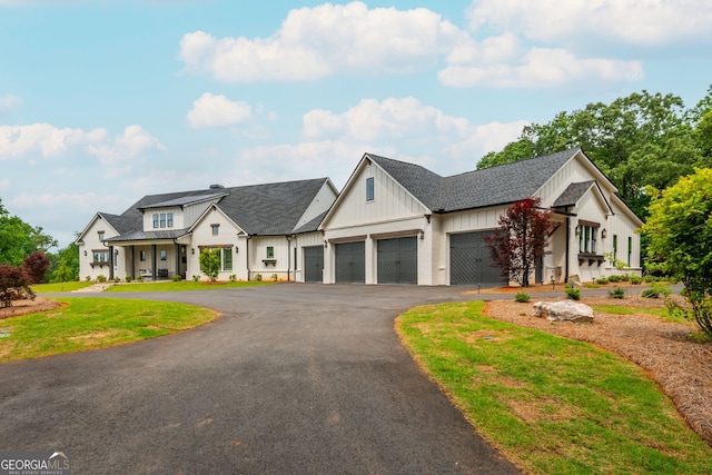 209 Voyles Way, Dawsonville, GA 30534 - modern farmhouse with board and batten siding, a garage, driveway, and a front yard