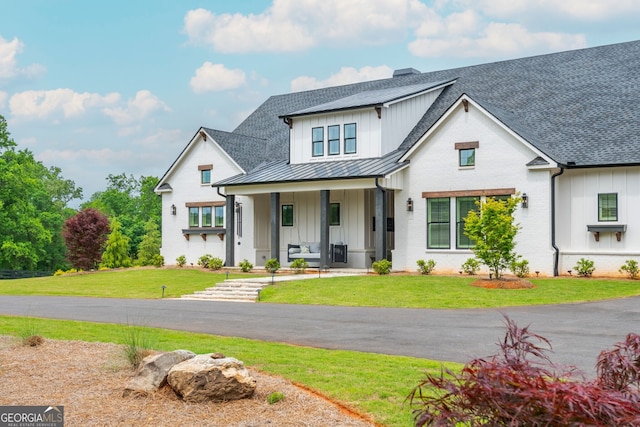 209 Voyles Way, Dawsonville, GA 30534 - modern inspired farmhouse with board and batten siding, a standing seam roof, covered porch, and a front yard