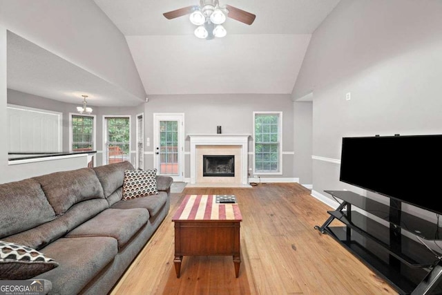 4544 Dorsett Shoals Run, Douglasville, GA 30135 - living room featuring vaulted ceiling, light wood-style flooring, ceiling fan, a high end fireplace, and plenty of natural light