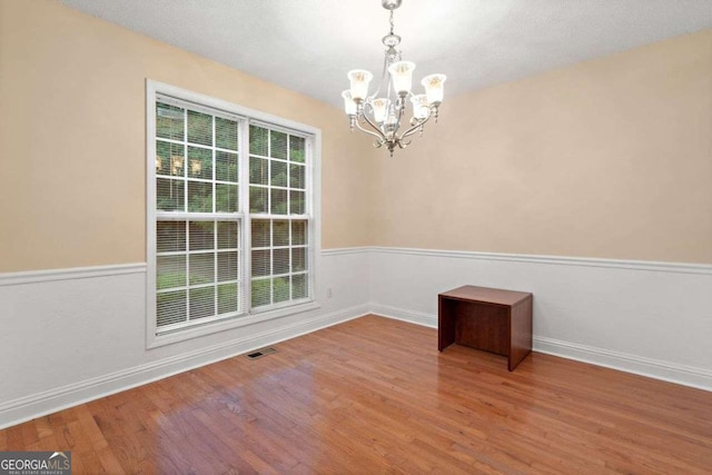 4544 Dorsett Shoals Run, Douglasville, GA 30135 - empty room featuring a chandelier and wood finished floors
