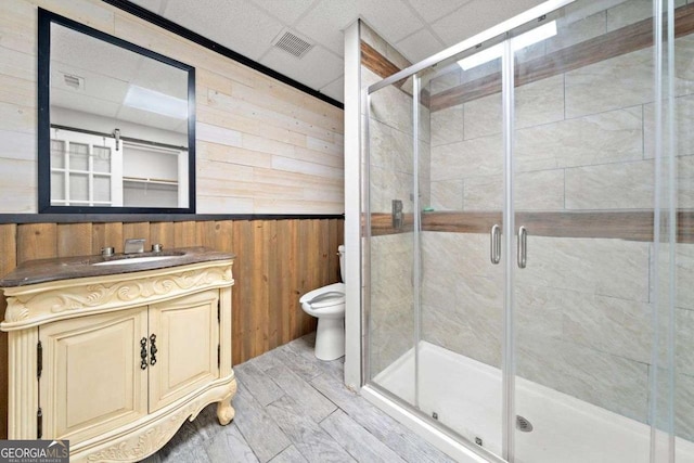 4544 Dorsett Shoals Run, Douglasville, GA 30135 - bathroom with wood walls, vanity, a stall shower, a drop ceiling, and a wainscoted wall