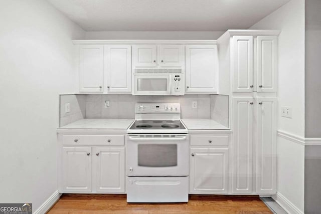 4544 Dorsett Shoals Run, Douglasville, GA 30135 - kitchen with white appliances, light wood finished floors, light countertops, and white cabinets