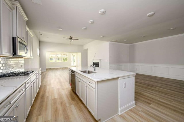 2856 Knob Creek Dr, Snellville, GA 30078 - kitchen with open floor plan, a sink, appliances with stainless steel finishes, ceiling fan, and light wood finished floors