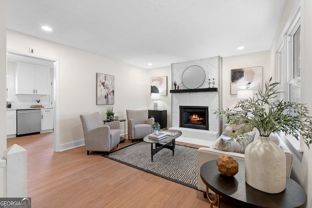 7000 Woodland Pl NW, Kennesaw, GA 30152 - living area featuring light wood finished floors, a fireplace, and recessed lighting