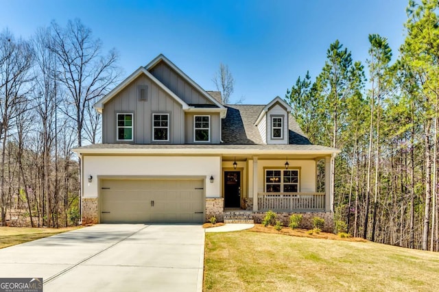 321 Shoals Trl, Dallas, GA 30132 - view of front of property featuring covered porch, board and batten siding, driveway, a garage, and a front lawn