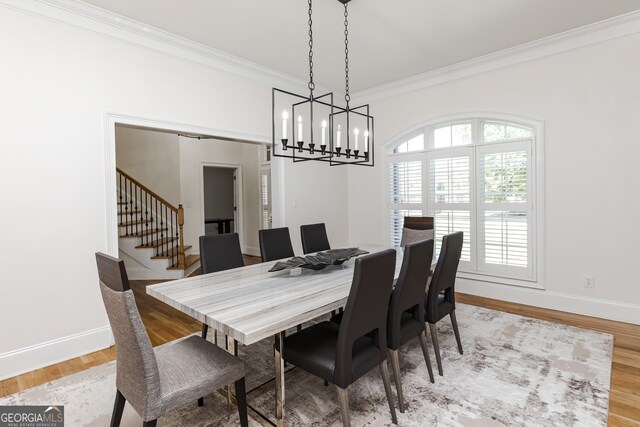 720 Latrobe Way, Macon, GA 31220 - dining space with a chandelier, crown molding, stairway, light wood finished floors, and baseboards