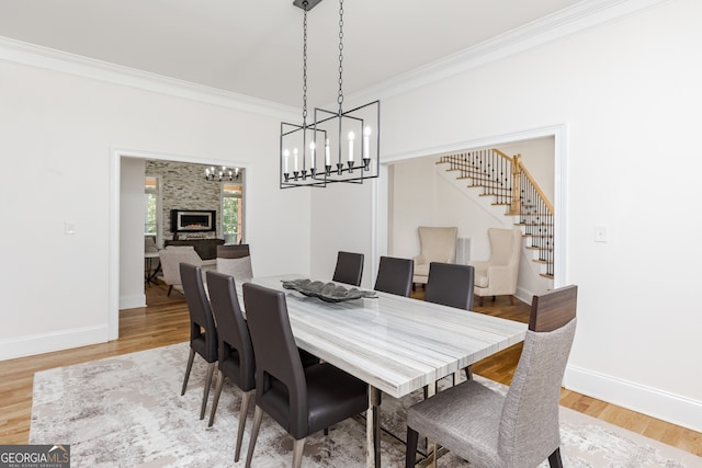 720 Latrobe Way, Macon, GA 31220 - dining room featuring stairway, a chandelier, ornamental molding, light wood-style floors, and baseboards