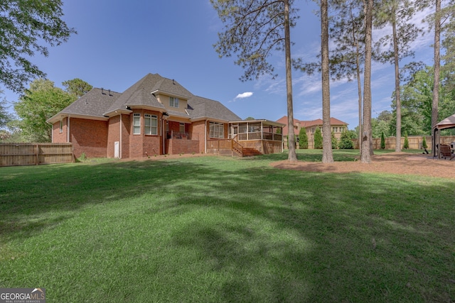 720 Latrobe Way, Macon, GA 31220 - rear view of house featuring a sunroom, brick siding, and a shingled roof