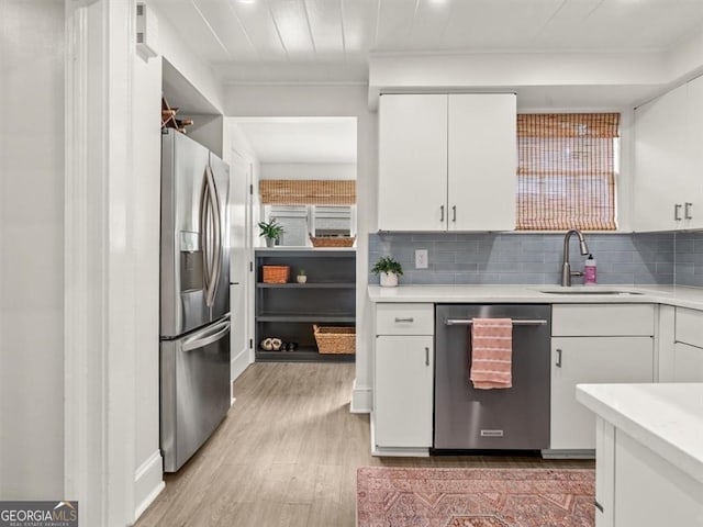 2054 Palifox Dr NE, Atlanta, GA 30307 - kitchen with appliances with stainless steel finishes, a sink, light countertops, white cabinets, and crown molding
