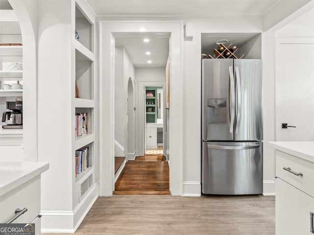 2054 Palifox Dr NE, Atlanta, GA 30307 - kitchen featuring stainless steel fridge with ice dispenser, arched walkways, light wood-type flooring, white cabinetry, and light countertops