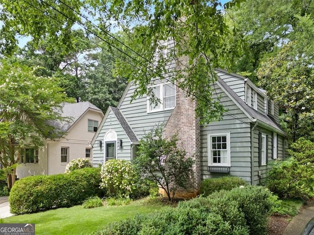 2054 Palifox Dr NE, Atlanta, GA 30307 - view of home's exterior featuring a yard and roof with shingles