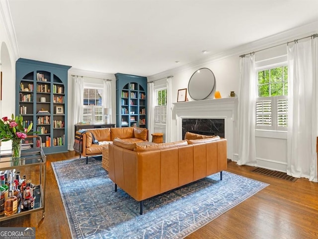 2054 Palifox Dr NE, Atlanta, GA 30307 - living room featuring crown molding, a fireplace, wood finished floors, and built in shelves