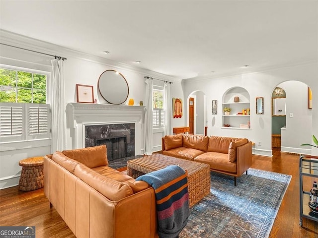 2054 Palifox Dr NE, Atlanta, GA 30307 - living area with arched walkways, built in features, ornamental molding, healthy amount of natural light, and a fireplace