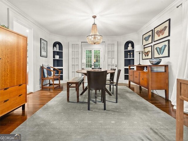 2054 Palifox Dr NE, Atlanta, GA 30307 - dining area with built in shelves, crown molding, a chandelier, and wood finished floors
