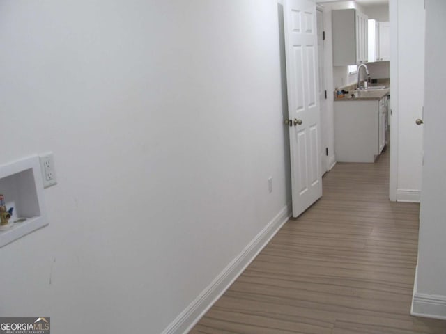 115 Red Hawk Ct, Waynesville, GA 31566 - hall featuring light wood-style flooring, baseboards, and a sink