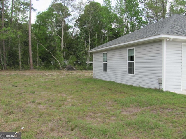 115 Red Hawk Ct, Waynesville, GA 31566 - view of green lawn featuring a garage