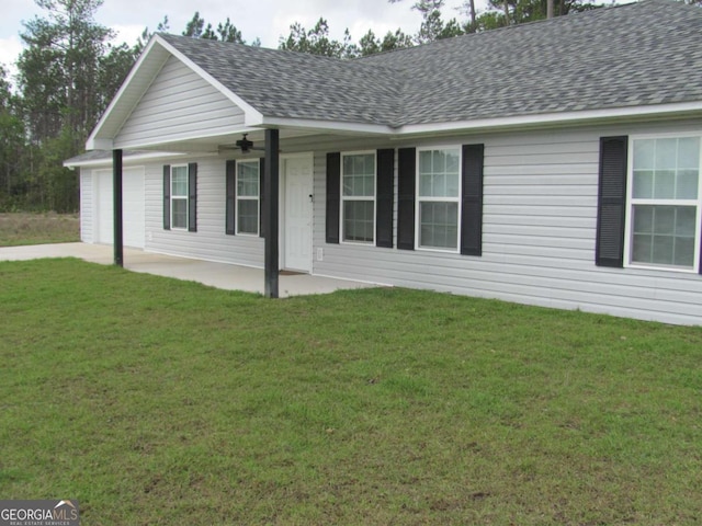 115 Red Hawk Ct, Waynesville, GA 31566 - ranch-style house featuring a garage, a shingled roof, and a front lawn