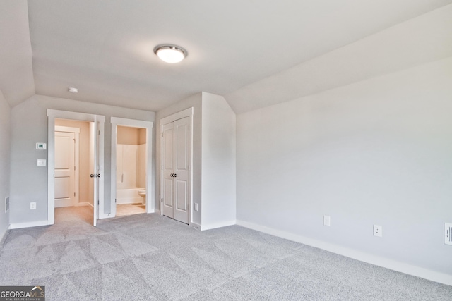 4063 Links Blvd, Jefferson, GA 30549 - unfurnished bedroom with carpet, baseboards, lofted ceiling, and ensuite bath